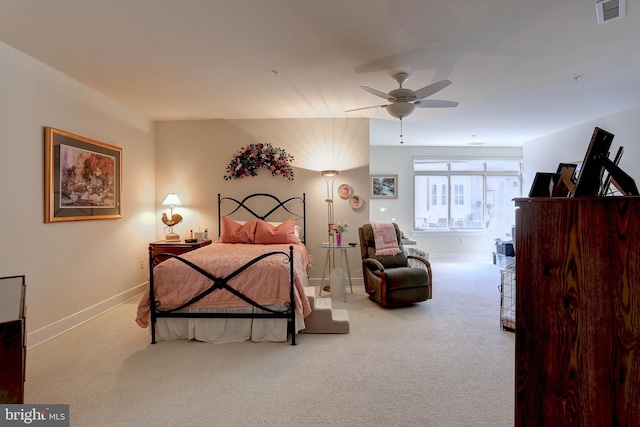 bedroom featuring a ceiling fan, light colored carpet, visible vents, and baseboards