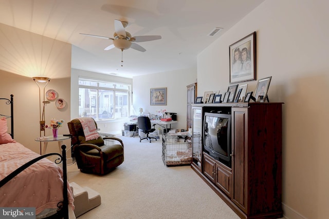 bedroom with visible vents, a ceiling fan, and light colored carpet