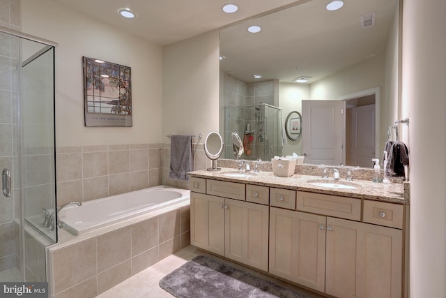 bathroom with a garden tub, tile patterned flooring, visible vents, and a sink