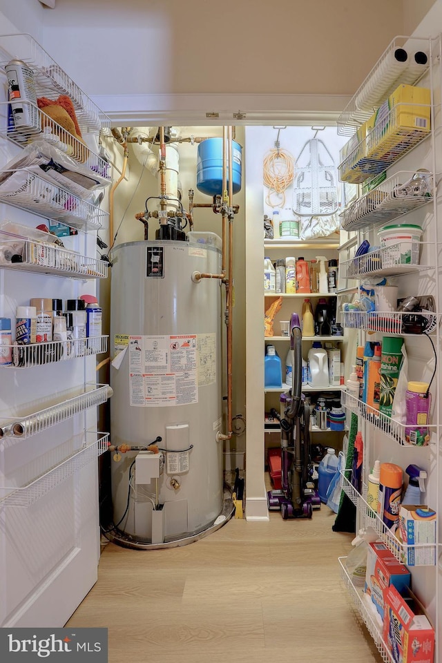 utility room featuring water heater