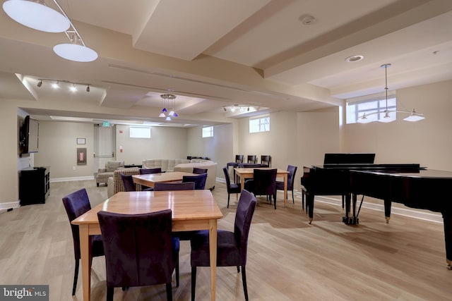 dining room featuring plenty of natural light, light wood-style flooring, and baseboards