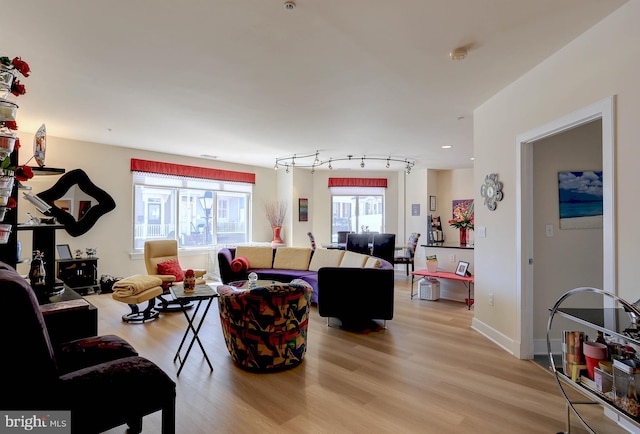 living area featuring light wood-type flooring and baseboards