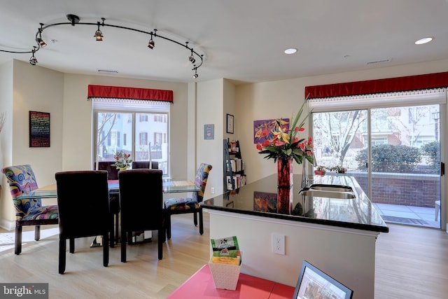 dining room with light wood-style floors, visible vents, track lighting, and recessed lighting