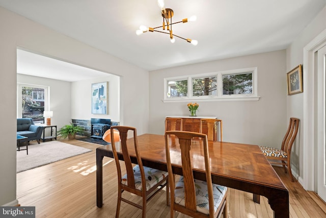 dining room with a chandelier and light wood-type flooring