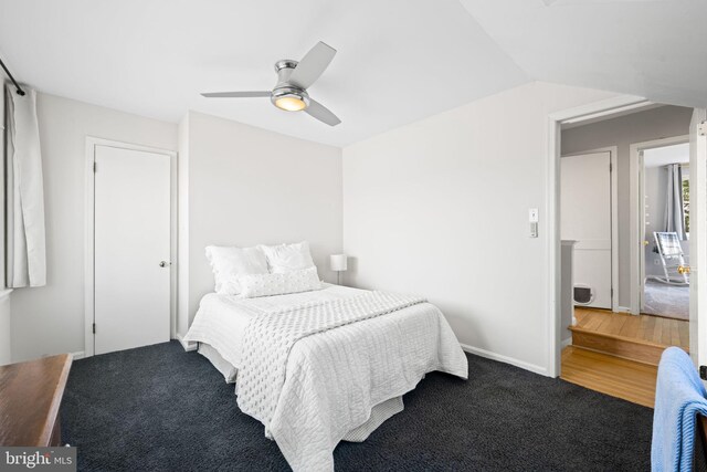 bedroom with lofted ceiling, ceiling fan, and baseboards