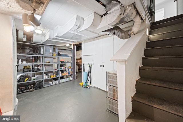 unfinished basement featuring stairway