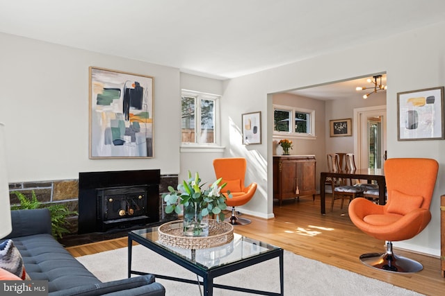 interior space with a fireplace, baseboards, and wood finished floors