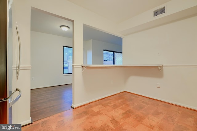 empty room with baseboards and visible vents