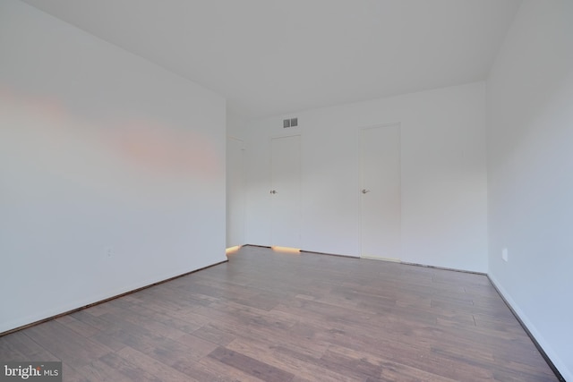 spare room with visible vents and wood finished floors