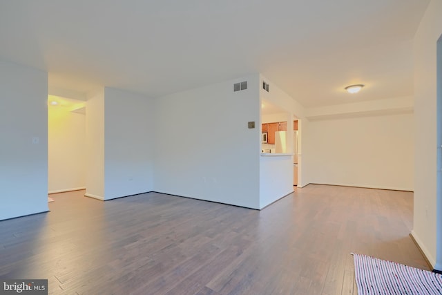 spare room with visible vents and wood finished floors