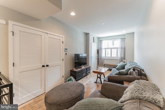 living area with light wood finished floors and recessed lighting