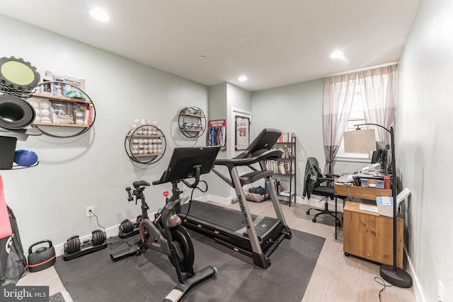 exercise room with light wood-style floors, recessed lighting, and baseboards