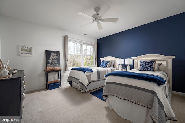 carpeted bedroom with baseboards, visible vents, and a ceiling fan