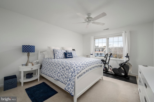 bedroom featuring baseboards, carpet flooring, visible vents, and a ceiling fan