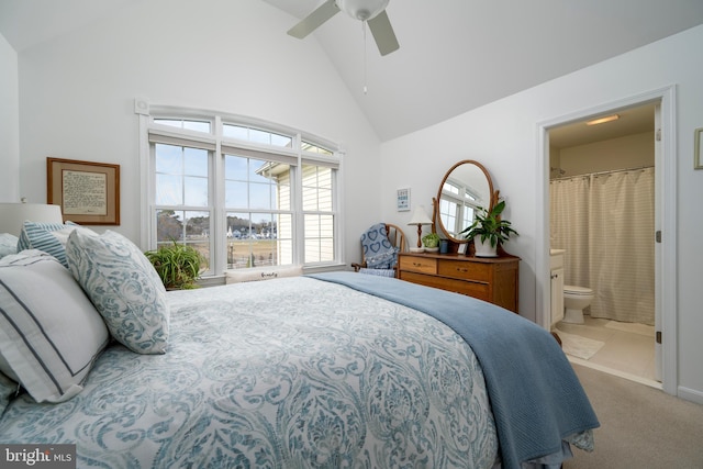 carpeted bedroom with high vaulted ceiling, ceiling fan, and ensuite bath