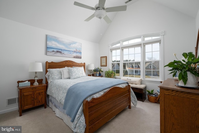 bedroom with high vaulted ceiling, light colored carpet, and visible vents