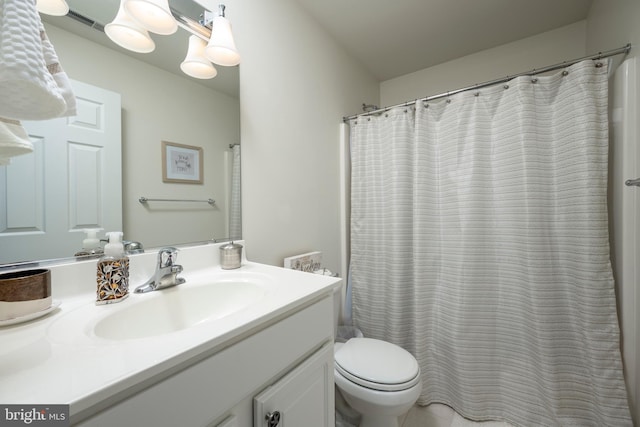 bathroom with toilet, visible vents, and vanity