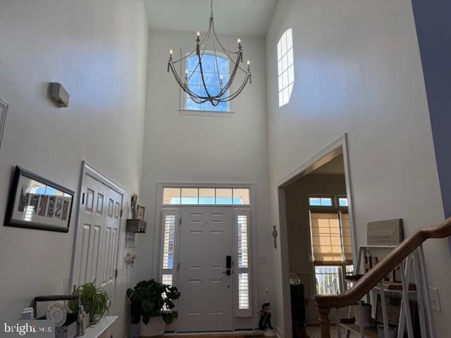 entryway with stairway and a notable chandelier