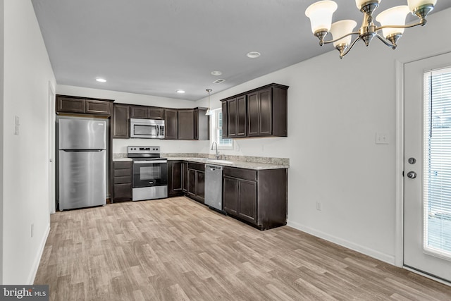 kitchen with baseboards, an inviting chandelier, stainless steel appliances, dark brown cabinets, and light wood-type flooring