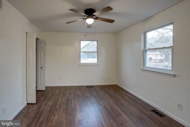 unfurnished bedroom featuring dark wood finished floors, visible vents, and baseboards