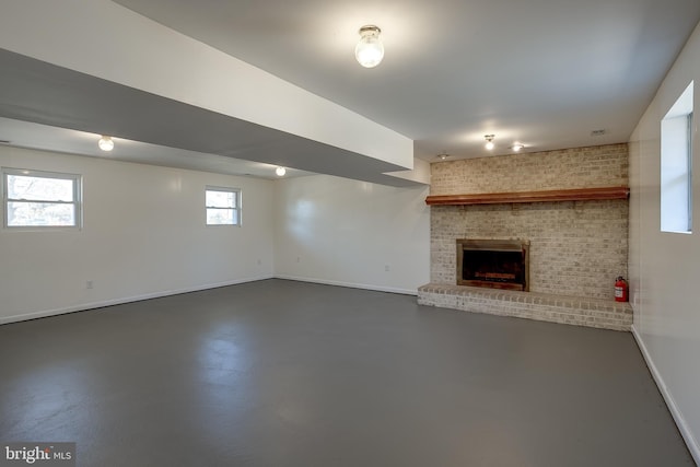 basement featuring a brick fireplace and baseboards