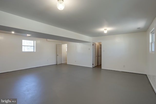 spare room with visible vents, baseboards, and concrete flooring