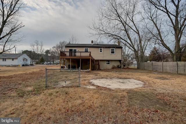 back of house with stairway, a chimney, fence, and a deck