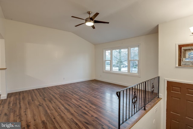 unfurnished living room with lofted ceiling, a ceiling fan, baseboards, and wood finished floors