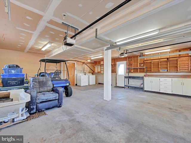 garage with a garage door opener and separate washer and dryer