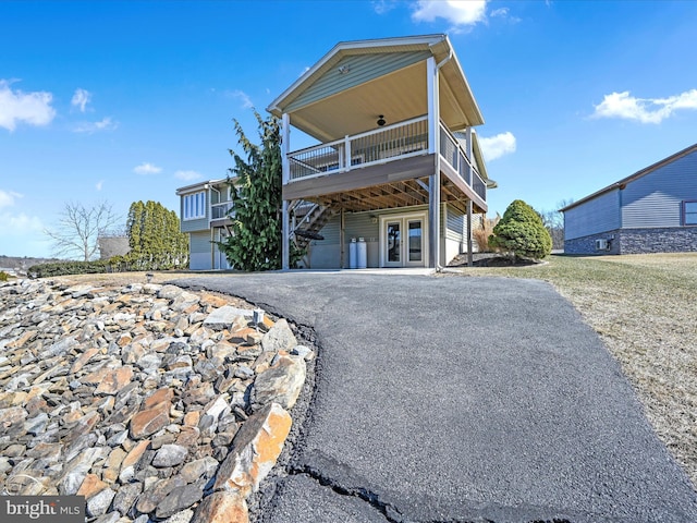 view of front of house featuring french doors and driveway