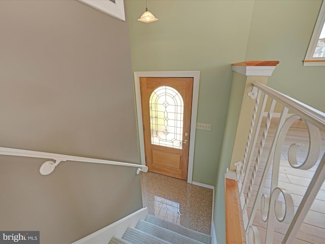 foyer featuring baseboards