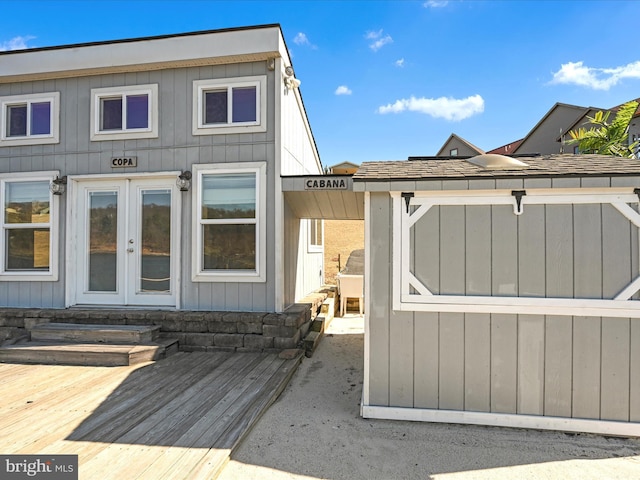 back of property with french doors and a wooden deck