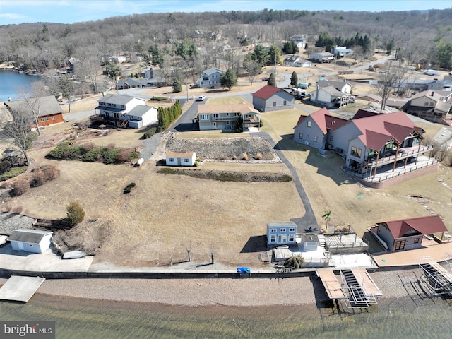 bird's eye view featuring a residential view and a water view