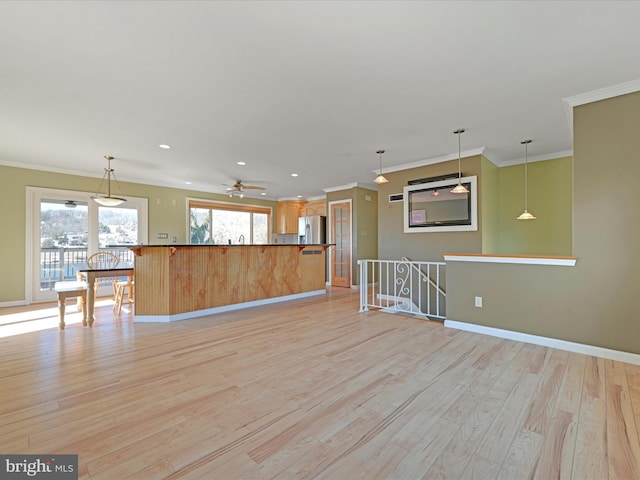 kitchen with baseboards, light wood-style flooring, ornamental molding, stainless steel refrigerator with ice dispenser, and dark countertops