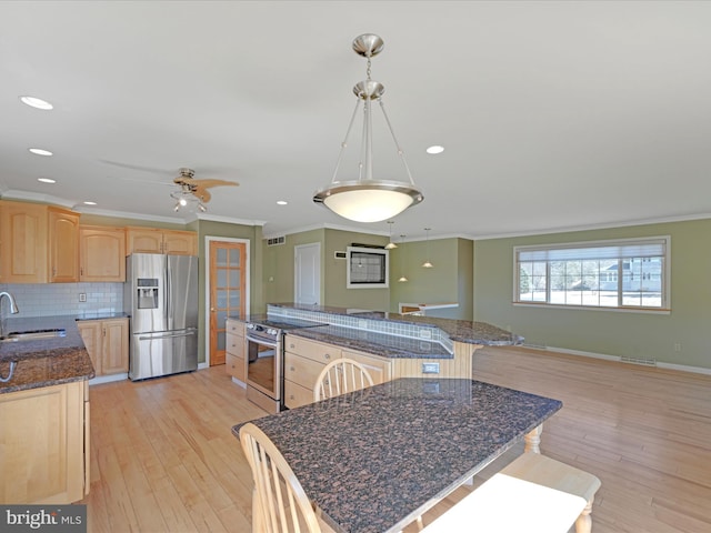 kitchen featuring a sink, appliances with stainless steel finishes, light brown cabinetry, and crown molding