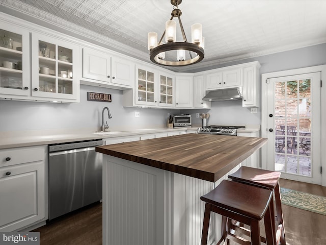 kitchen with an ornate ceiling, stainless steel dishwasher, a sink, wood counters, and under cabinet range hood