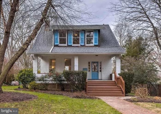 bungalow-style home with covered porch and a shingled roof