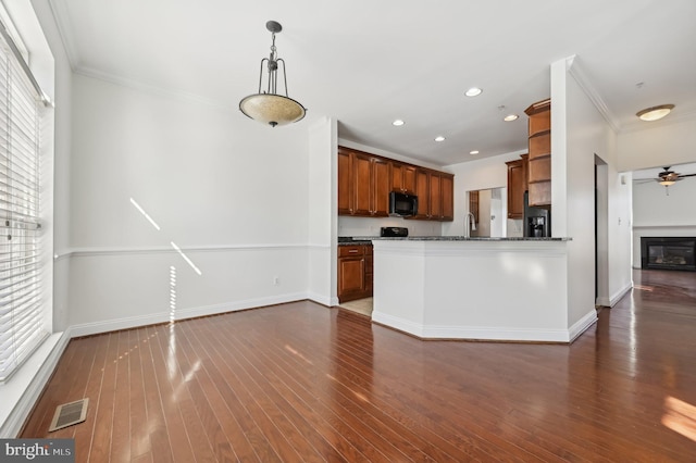 kitchen featuring brown cabinets, visible vents, a ceiling fan, open floor plan, and black appliances