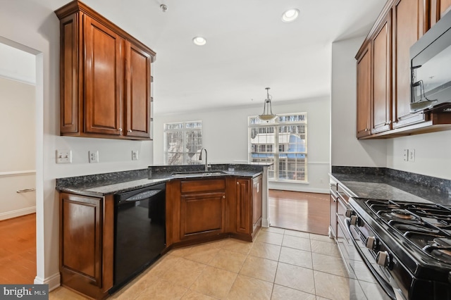 kitchen with dishwasher, a sink, stainless steel stove, and brown cabinets