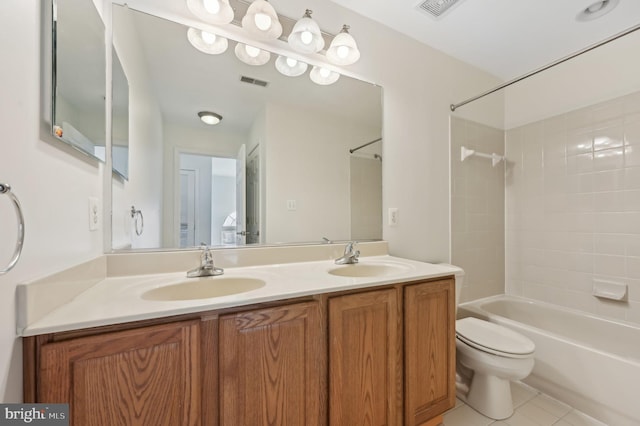 bathroom featuring toilet, visible vents, and a sink