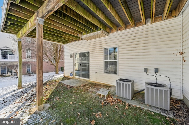 snow covered patio featuring central AC unit