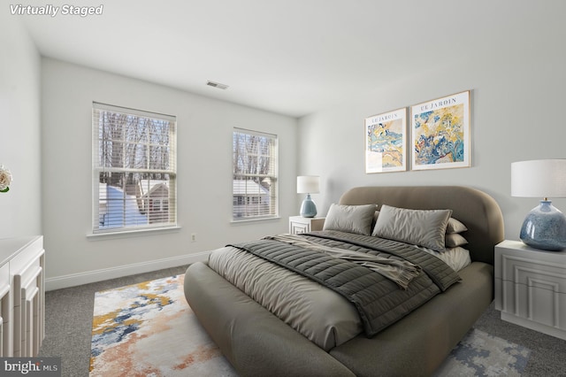 bedroom featuring carpet, visible vents, and baseboards