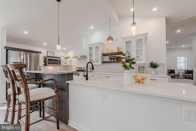 kitchen with custom exhaust hood, appliances with stainless steel finishes, open shelves, and white cabinets