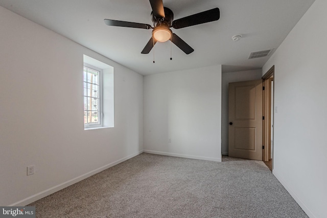 unfurnished room featuring light colored carpet, visible vents, and baseboards