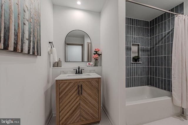 bathroom featuring baseboards, vanity, and shower / bathtub combination with curtain