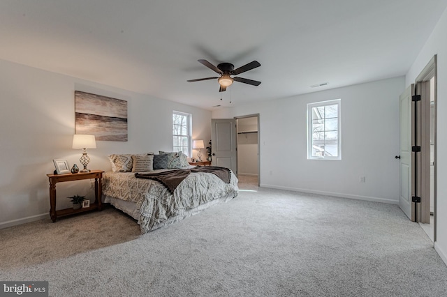 carpeted bedroom with visible vents, ceiling fan, and baseboards