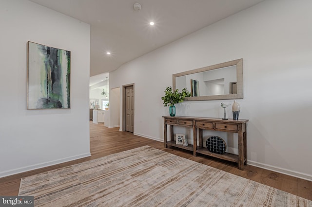 hall with baseboards, wood finished floors, and recessed lighting