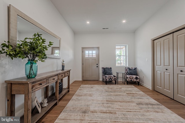 entrance foyer with baseboards, visible vents, wood finished floors, and recessed lighting