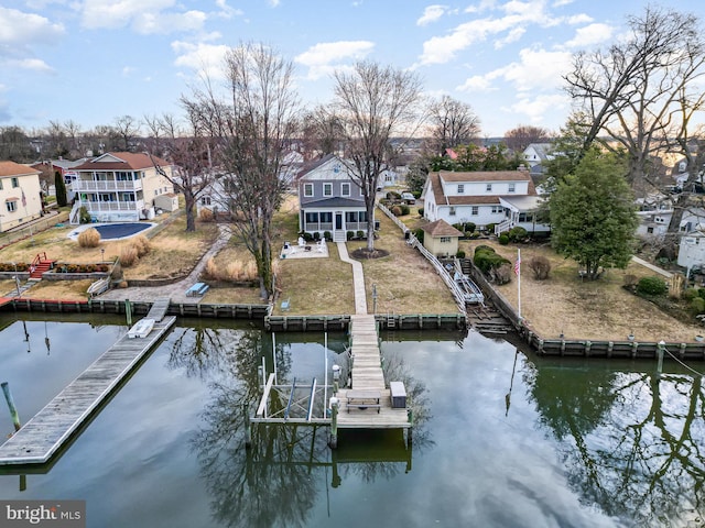 view of dock featuring a residential view and a water view