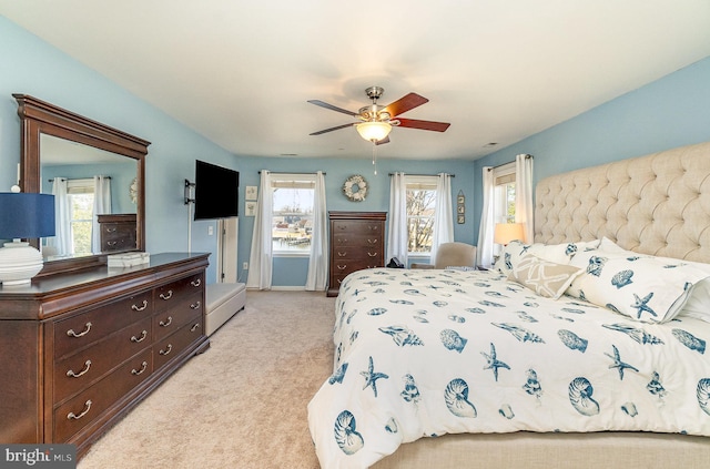 bedroom featuring light colored carpet and ceiling fan